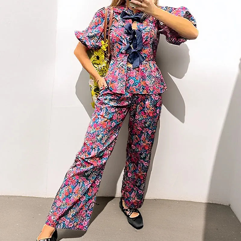 Women's floral print trousers suit with tie-neck top and puff sleeves