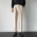 Men's straight-loose fit suit trousers in apricot colour hanging on a hanger.