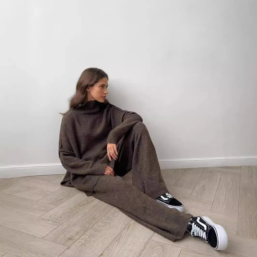 Women's dark grey side-slit sweater and trousers suit set on a hanger