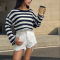 A woman's striped long-sleeve pullover sweater with a front and back wearable design in mercerised cotton.