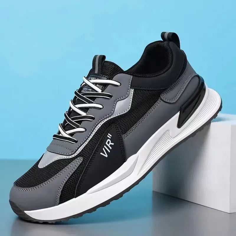 Men's colour block mesh running sneakers in black, grey, and white on a plain background.