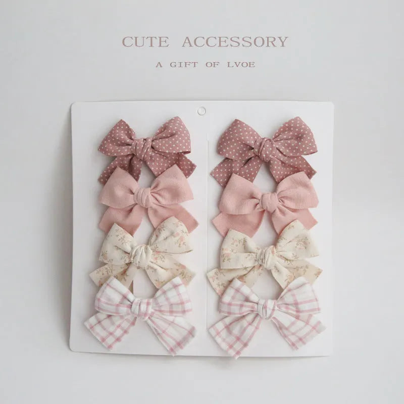 Children's fabric dovetail bow hair clips in eight pattern options