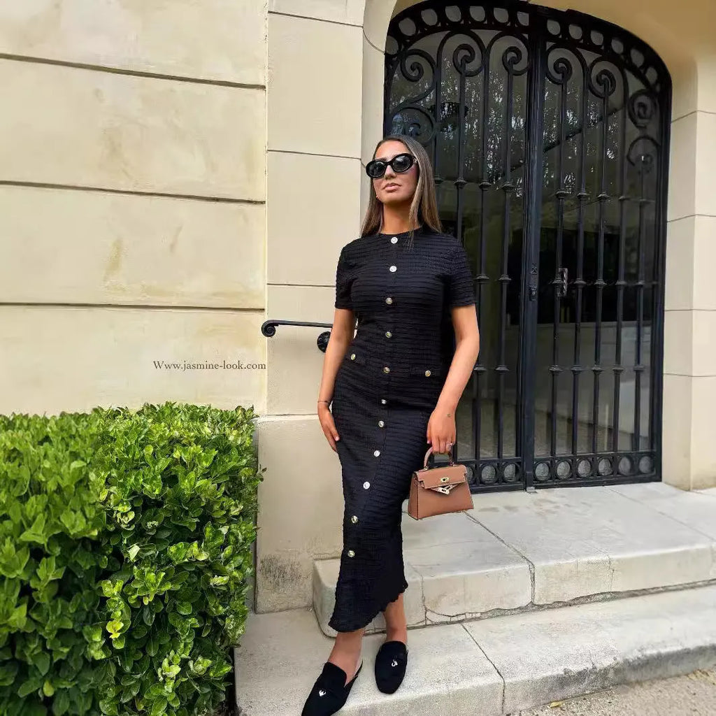 Black slim fit knitted dress with long sleeves, a French retro collar, and button detailing.
