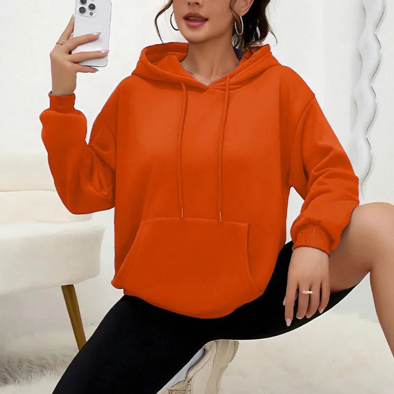 A loose-fitting women's long-sleeve sweatshirt with a drawstring pocket, shown in a solid colour.