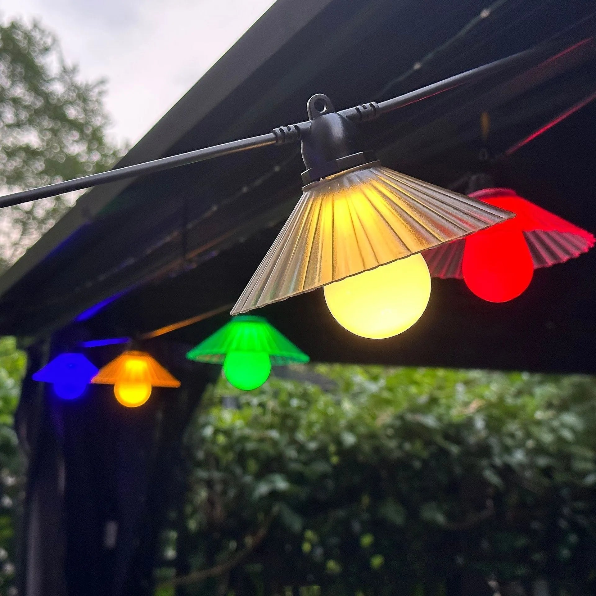 Outdoor LED string lights with flower-shaped bulbs in warm white and colour options.