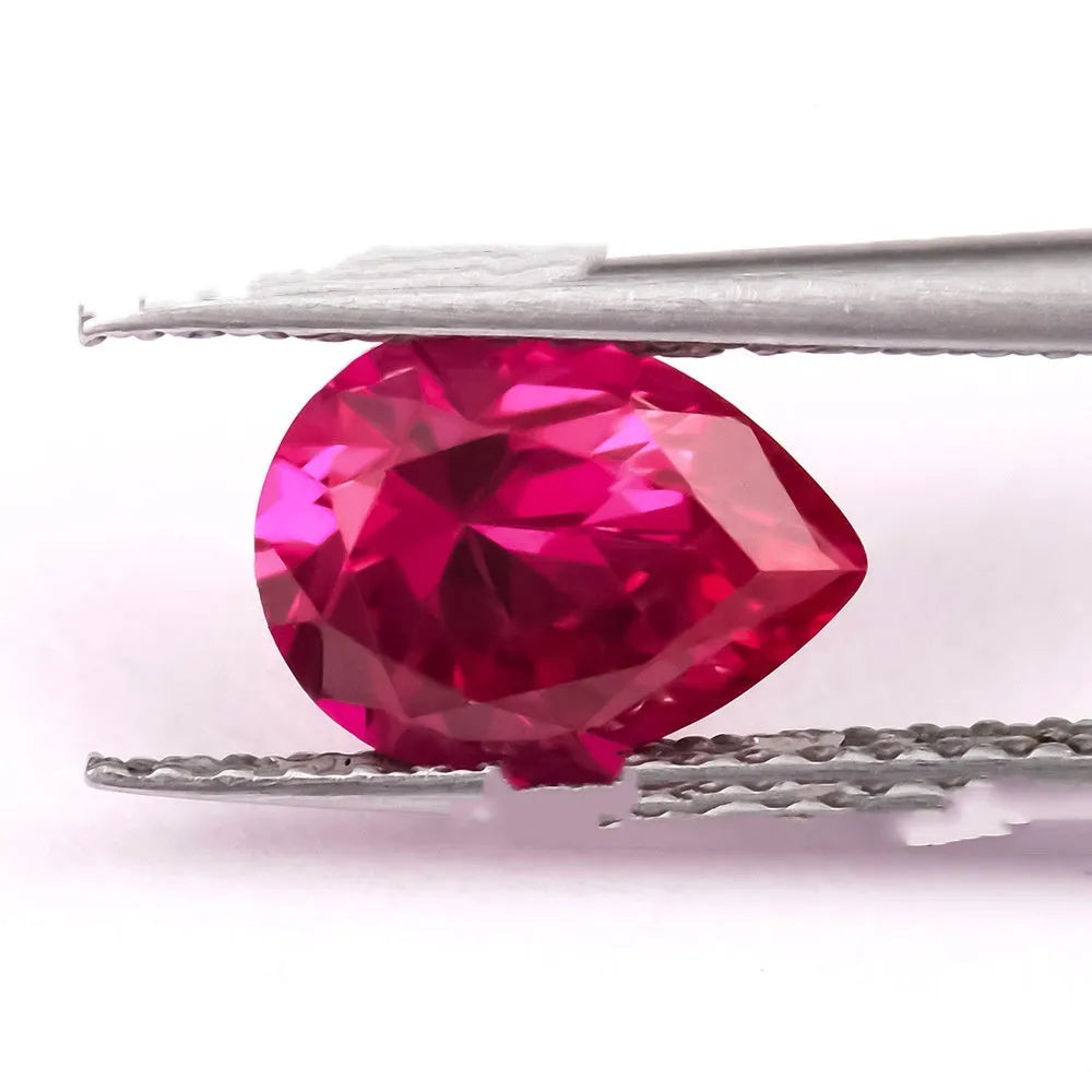 Laboratory-created pigeon blood red ruby gemstone showing different cutting styles including round, princess, and water drop