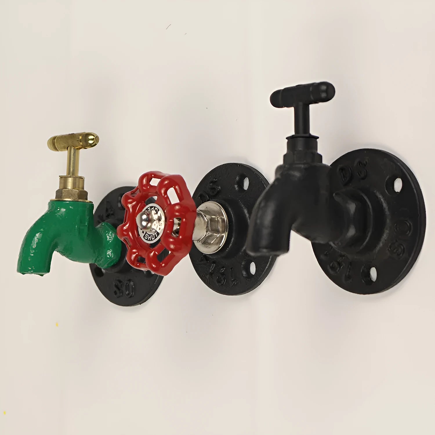 A polished metal wall hook in a water pipe design, shown in black, green, and red colour options.
