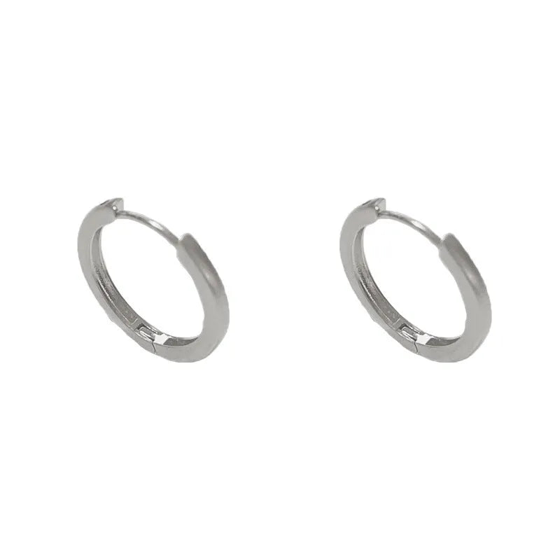 Women's geometric eyelet ear clip in gold or silver colour with round elements on copper base
