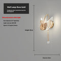 Gold minimalist swan wall lamp with acrylic shade mounted beside bed