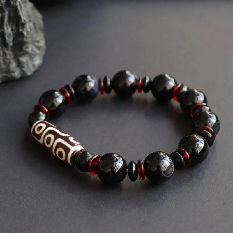 Black agate dzi bead bracelet with geometric pattern and hand-woven construction