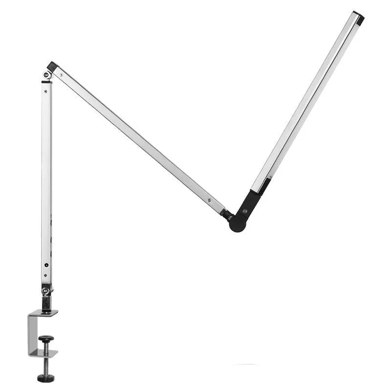 Folding aluminium desk lamp with a metal clip, shown in dazzling black, attached to a desk edge.