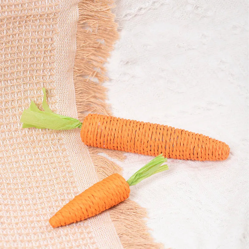 Assortment of cat toys including paper carrot bites, ringing stones, interactive sticks, and dental grinding sticks