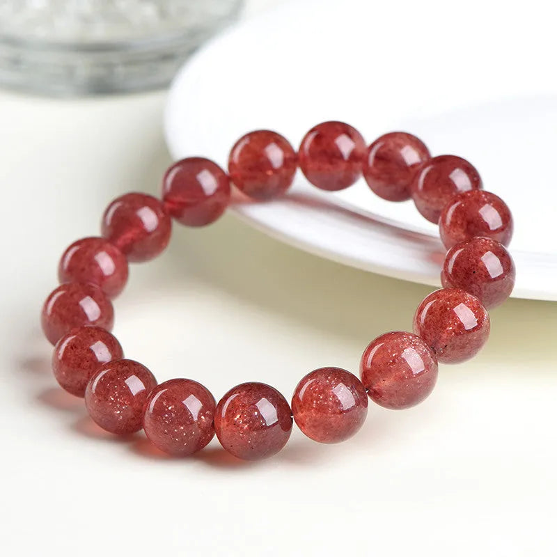 A bracelet made of geometrically cut, pink strawberry quartz beads in three size options.