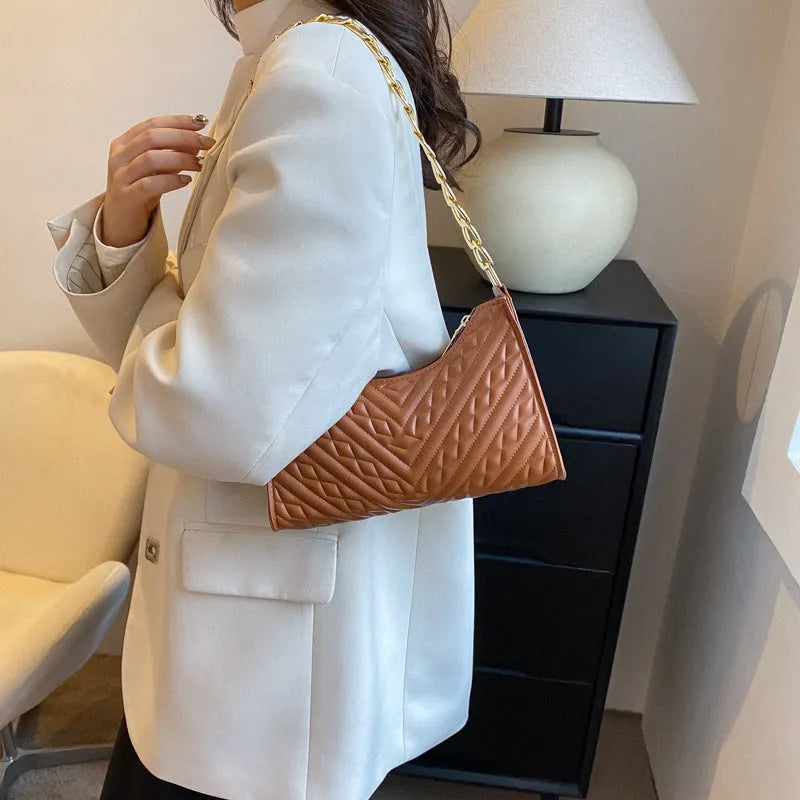 Brown pleated chain baguette shoulder bag showing vertical square shape and adjustable 50cm strap