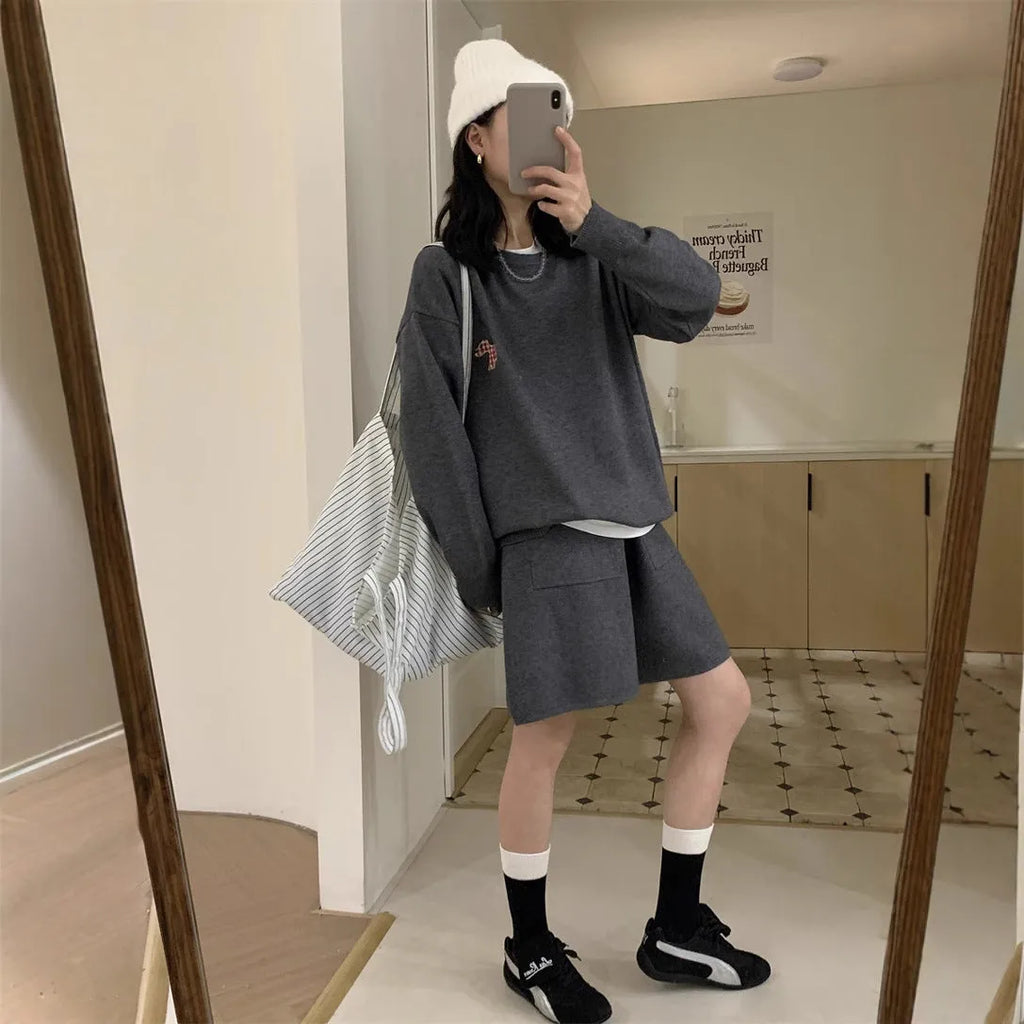 Women's milk blue casual knitted sports suit with animal embroidery on top and matching shorts.