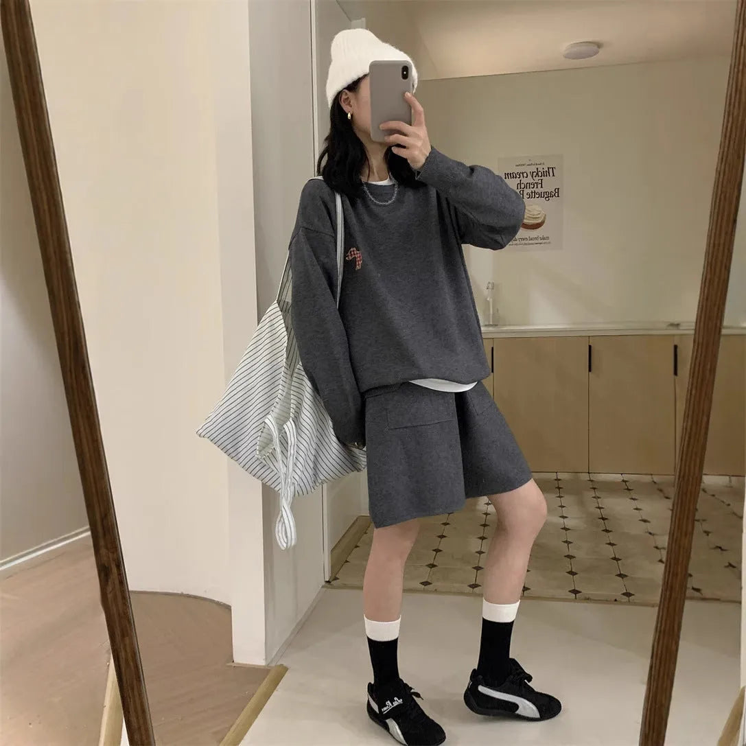 Women's milk blue casual knitted sports suit with animal embroidery on top and matching shorts.