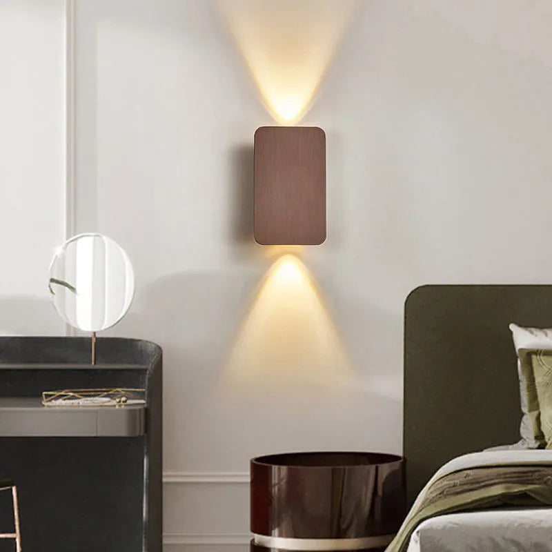 Minimalist modern LED wall lamp in black finish mounted on a wall