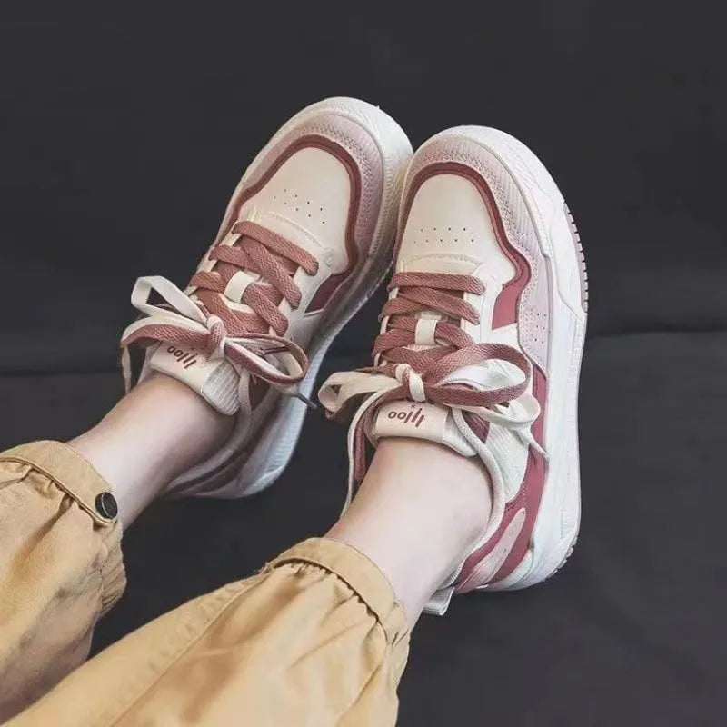Women's pink and white low-top sneaker with rubber sole for height increasing