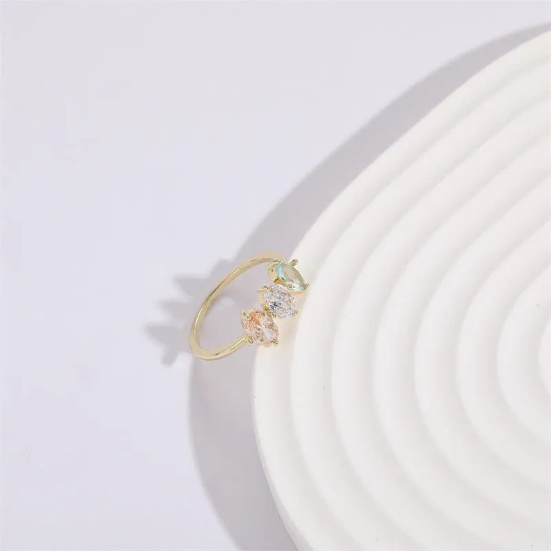 Gold electroplated geometric women's ring with triangular elements and horse eye tricolor zircon birthstone