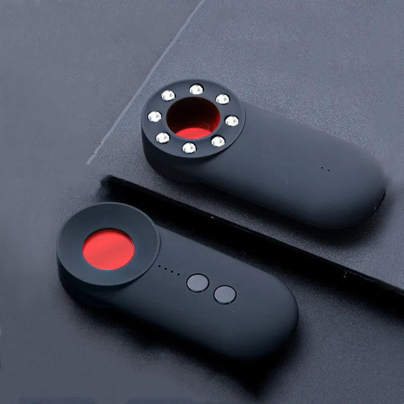 Black handheld GPS and camera detector with display, measuring 93.8mm long, shown with a USB charging cable.