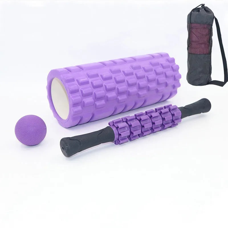Black 33cm fitness foam roller with six gear massage bar pieces on grey background
