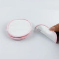 Set of four red and four blue round velvet makeup remover pads next to a cotton mesh drawstring bag.