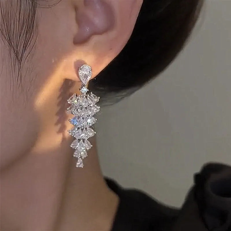 Silver pagoda Christmas tree drop earrings with sparkling zircon crystals on copper studs.
