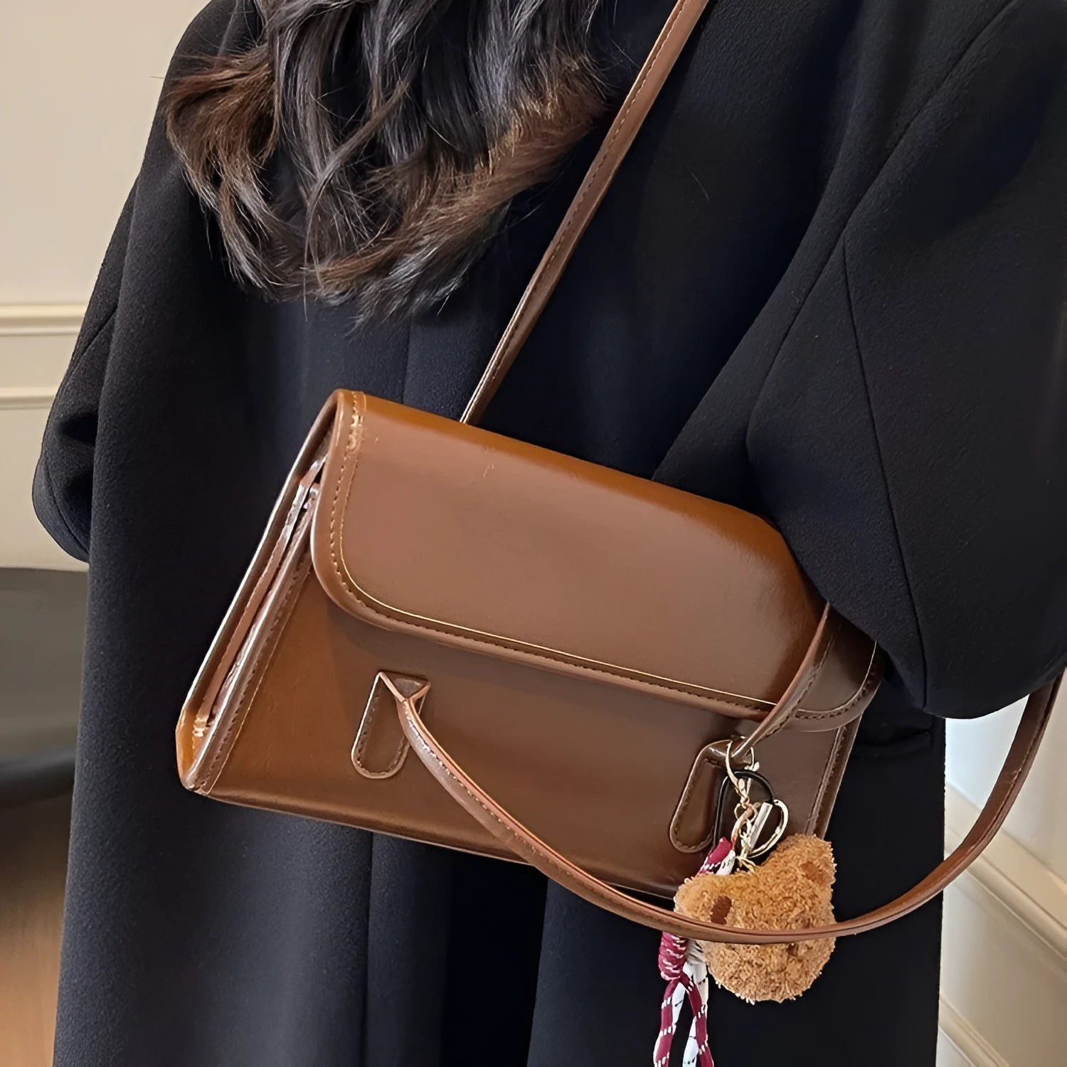 Women's brown PU leather shoulder bag with square shape, double straps, and decorative pendant attachment
