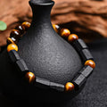 Natural obsidian bracelet with constellation design, 8mm wide, on a wrist.