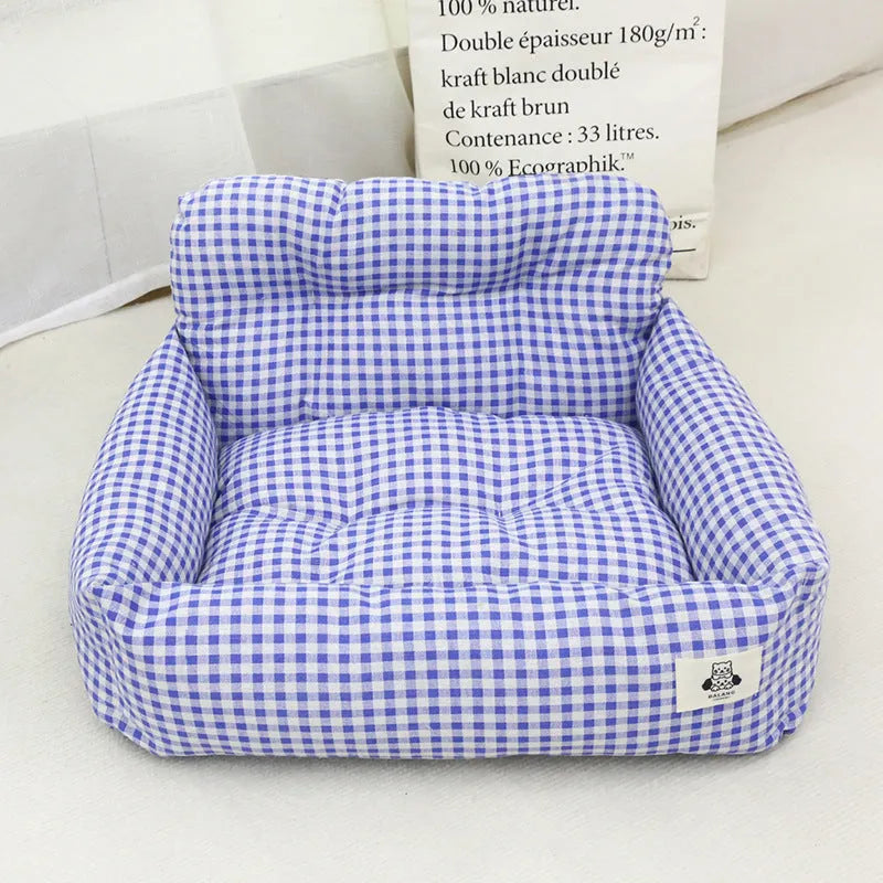 Blue plaid fabric car-mounted dog travel nest for small or medium dogs on a car seat