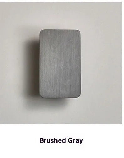 Minimalist modern LED wall lamp in black finish mounted on a wall