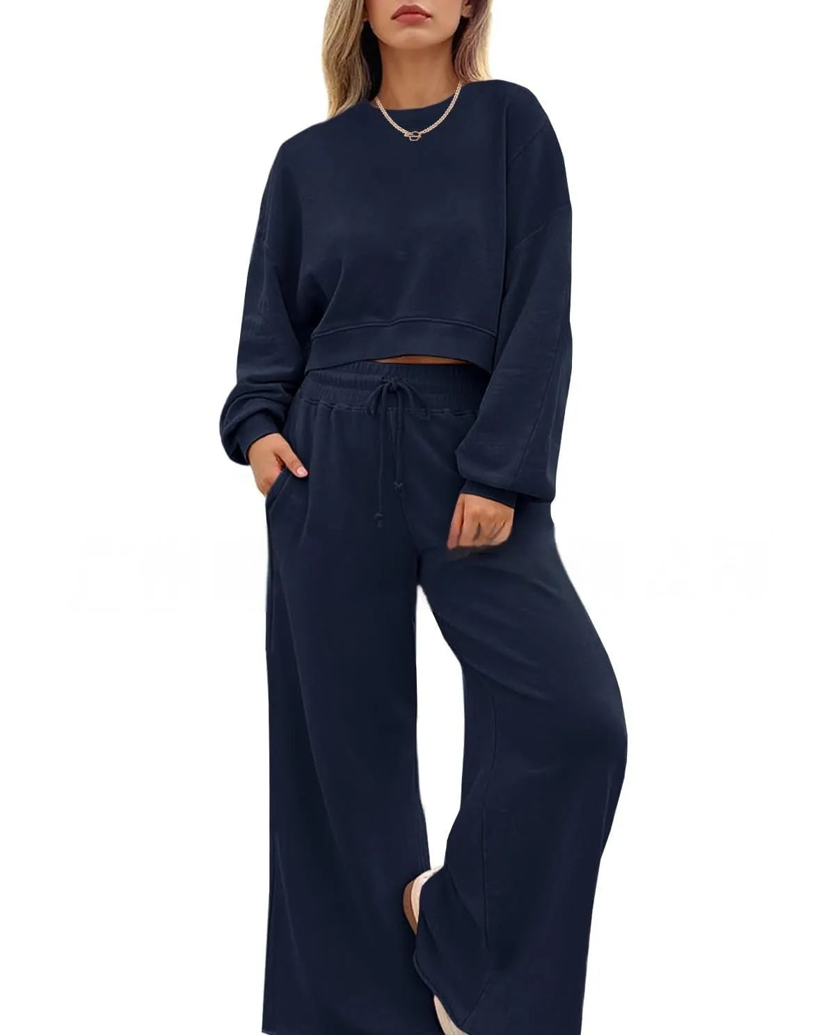 Women's solid colour long sleeve top and trousers two-piece set in polyester fabric.