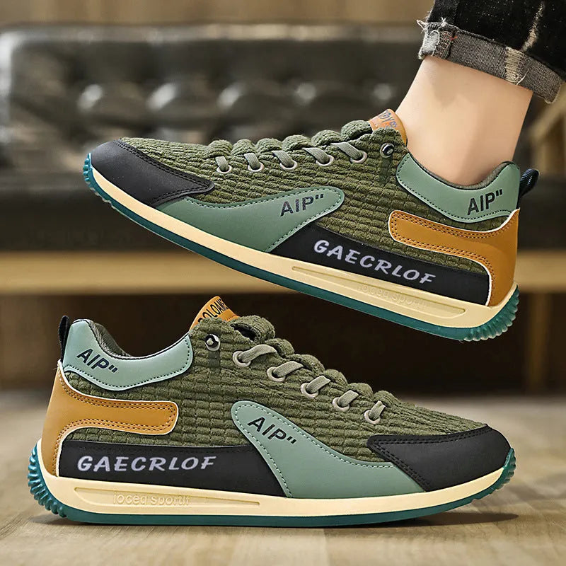 Men's low-top green mesh running shoes with white laces on a grey sole