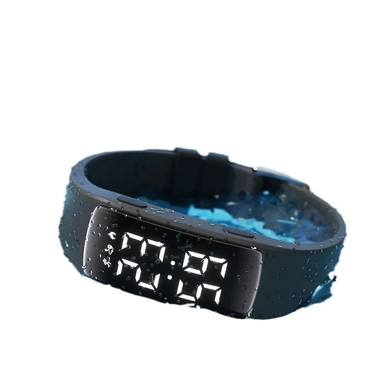 Black vibration alarm smart watch with LED display and silicone strap on a wrist.