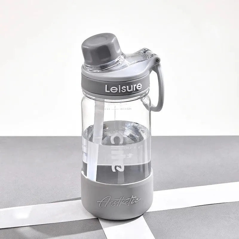 Grey cartoon patterned plastic cup with built-in straw showing 1000ml capacity marking