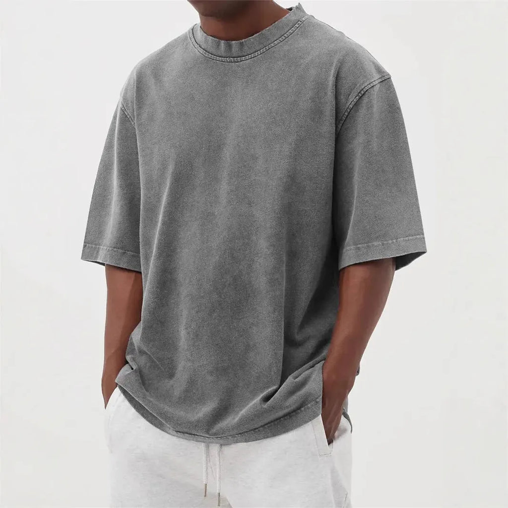 Men's loose fit pullover T-shirt in a stone-washed distressed solid colour, shown in army green.