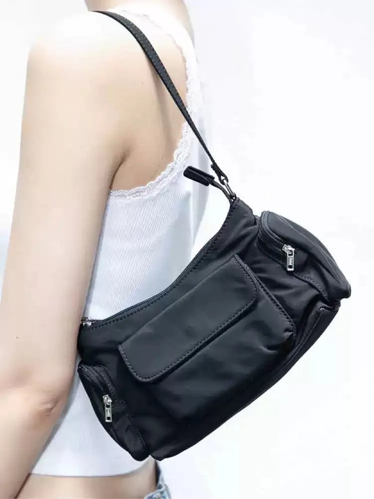 Black PU leather women's shoulder bag with double pockets and side line detail.