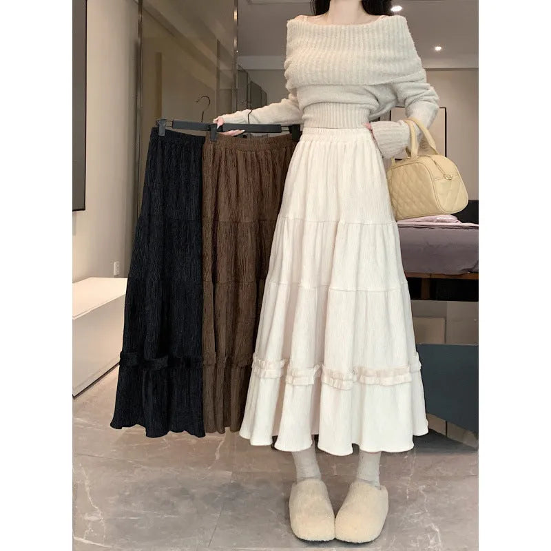 Women's beige corduroy A-line midi skirt with elastic waistband laid flat