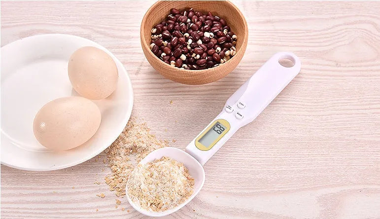 Black electronic measuring spoon scale showing digital display, 23.2cm long.