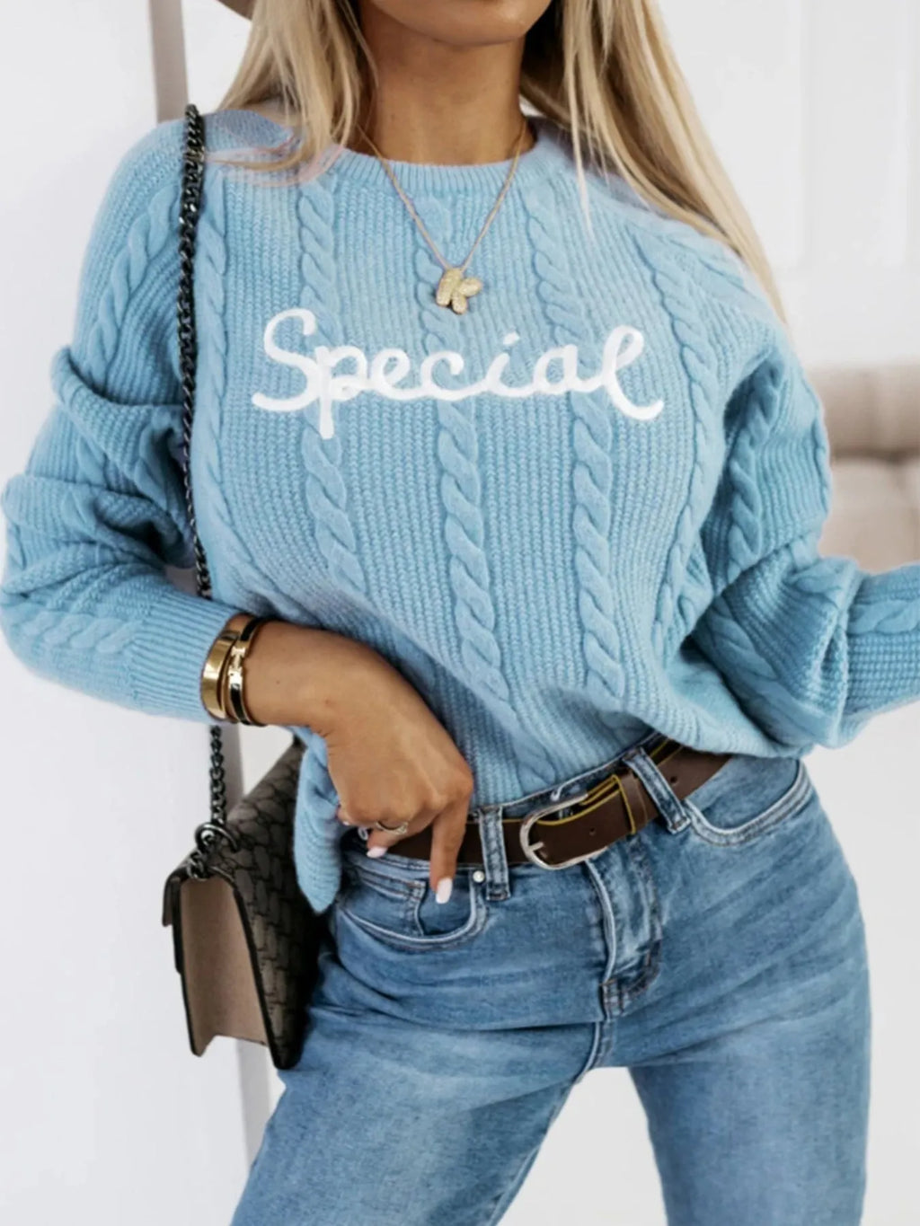 Blue leisure pullover sweater with white embroidered lettering and numbers on the front.