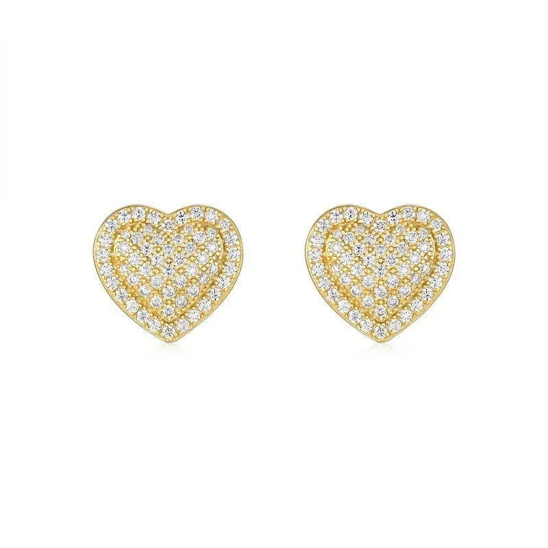 A pair of golden-colour heart stud earrings with a central moissanite stone, on a silver background.