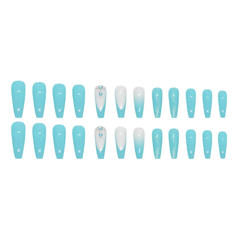 Long ballet shaped artificial nail patches with blue diamond glitter on a solid colour background, shown with a bottle of nail glue.