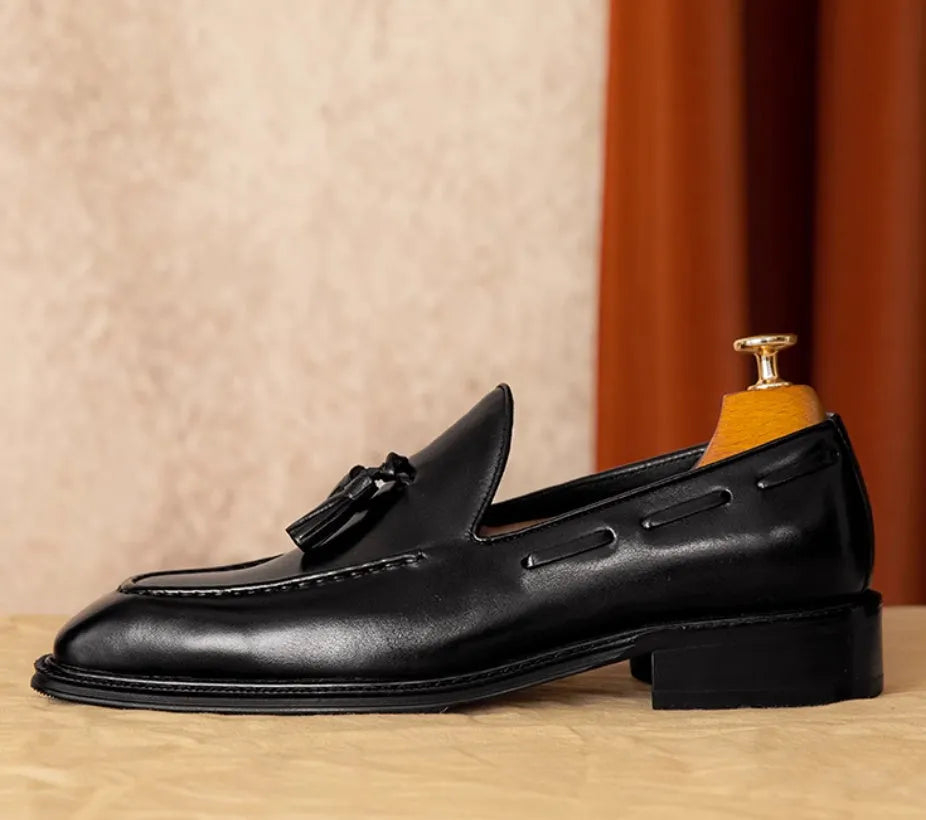 Men's black genuine leather slip-on loafers with a polished finish and rubber sole