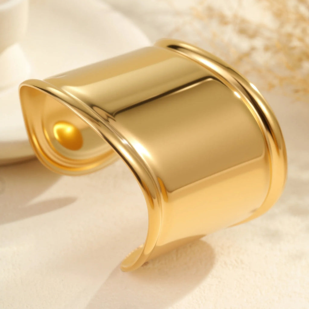 Women's exaggerated wide stainless steel bracelet with 18K gold plating and geometric wave design