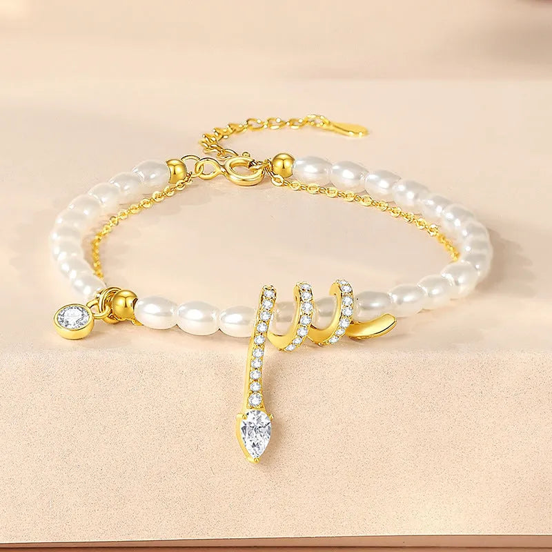 Pearl snake bracelet in 925 silver with electroplated gold or white gold colour on a wrist.