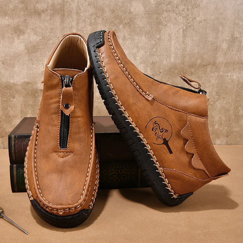Men's black slip-on loafers with round toe and sewing thread detail on a rubber sole.