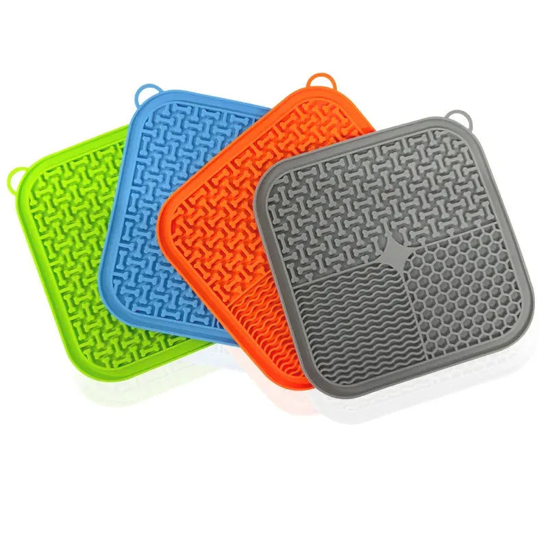 Blue silicone dog licking mat with textured surface and suction cups on back.