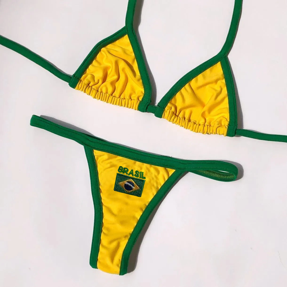 Women's yellow T-back bikini set with shorts-length briefs on a mannequin.