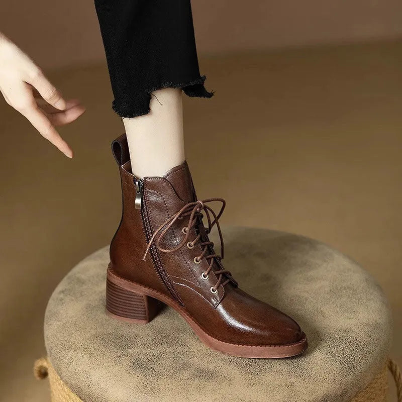 Women's black pointed-toe short ankle boots with a 5.5cm heel on a plain background.