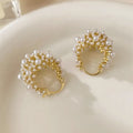 Gold copper flower basket earrings with small rice-shaped bead decoration and pearl inlay.